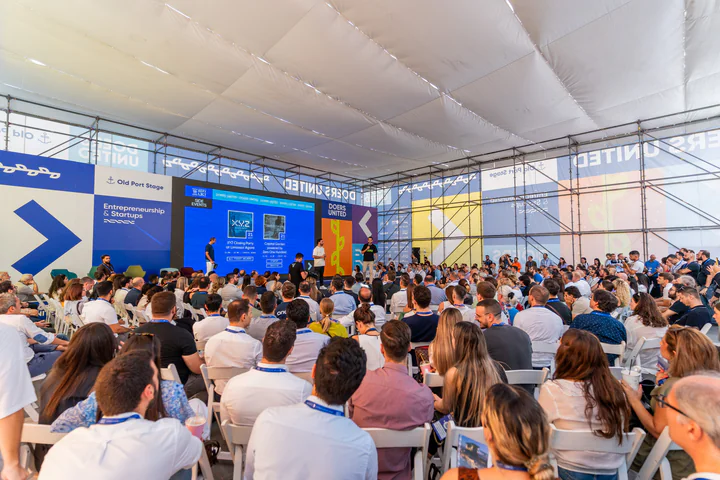 A packed Old Port Stage tent, the audience facing a Doers United screen