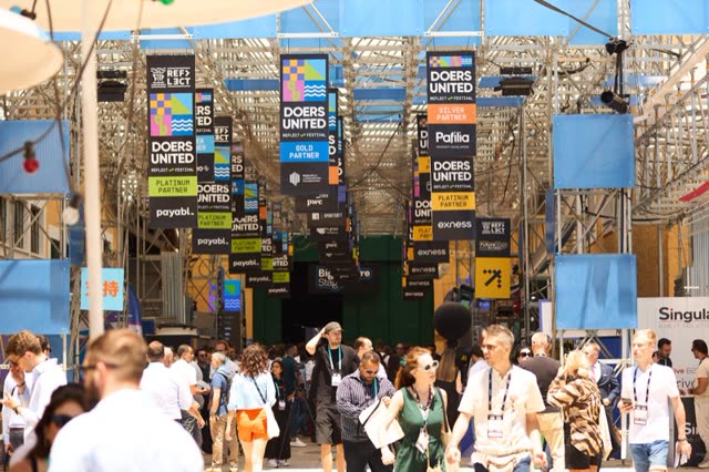 The expo boulevard at Doers Summit, lined with flags