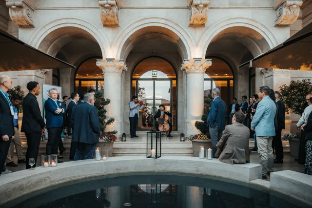 An evening reception in an arcaded courtyard